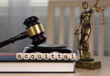 Border Stop Blunder — Stunning Acquittal A gavel and the word acquittal spelled with letter blocks on a desk