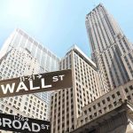 Wall Street’s Secret Strategy to Halt Trump Street signs for Wall Street and Broad Street with skyscrapers in the background
