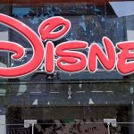 MASSIVE Disney Meltdown Rocks Wall Street Bright red Disney logo displayed on a storefront window