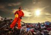 Toxic Cloud TRAPS 1,000 Oklahoma Residents Person in protective gear standing on a landfill with a yellow container