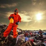 Toxic Cloud TRAPS 1,000 Oklahoma Residents Person in protective gear standing on a landfill with a yellow container