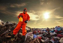 Toxic Cloud TRAPS 1,000 Oklahoma Residents Person in protective gear standing on a landfill with a yellow container