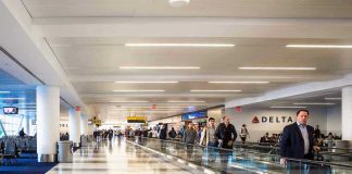 People walking through a busy airport terminal.