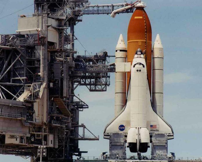 132394 Space shuttle on launch pad with support structure.