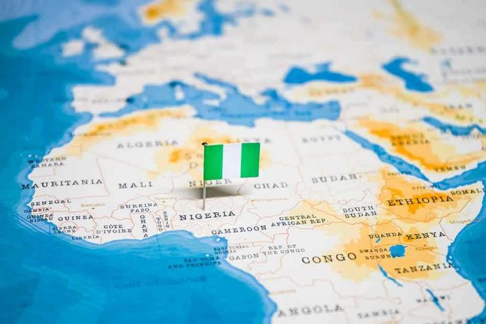 Flag pin marking Nigeria on Africa map.