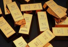 Gold-Silver Divergence Sparks Panic Gold bars stacked on dark background