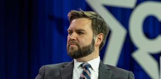 Vance Takes BRUTAL Navy SEAL Beating Man in a suit with a thoughtful expression.