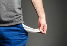 Middle-Class Trapped in “Valley of Death” Person pulling out empty pocket from shorts.