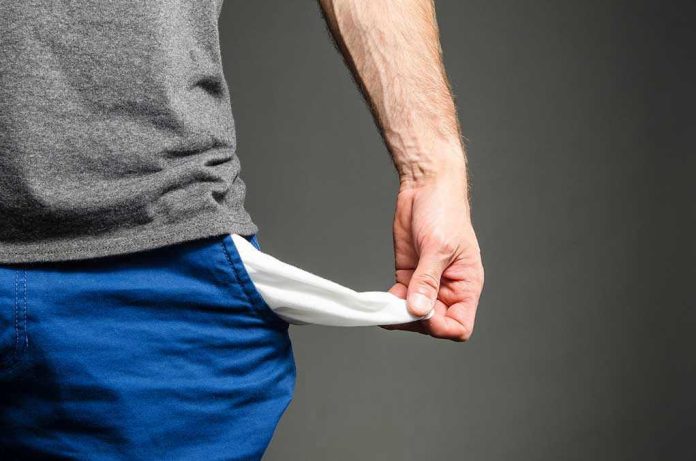 318205070 Person pulling out empty pocket from shorts.