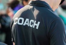 Person wearing a shirt labeled Coach.