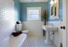 Modern bathroom with blue walls and white fixtures.
