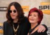 SHOCKING Encounter Stops Sharon Osbourne’s Suicide Plan A celebrity couple posing together at a red carpet event, smiling and dressed in stylish outfits