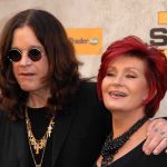 SHOCKING Encounter Stops Sharon Osbourne’s Suicide Plan A celebrity couple posing together at a red carpet event, smiling and dressed in stylish outfits