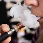 Teen’s BLACK Lungs SHOCK Doctors After Vaping Close-up of a person vaping, exhaling smoke clouds