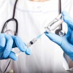 Medical Establishment STUNNED by RFK’s Dangerous Gamble Doctor filling syringe with vaccine from vial.