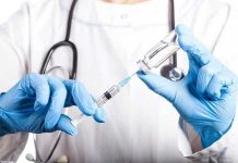 Medical Establishment STUNNED by RFK’s Dangerous Gamble Doctor filling syringe with vaccine from vial.