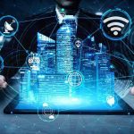 Holographic city above tablet with technology icons.