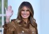 Melania DEMOLISHES Traditional First Lady Playbook Completely Person smiling and waving wearing a brown coat