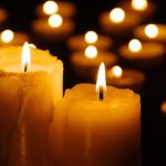 Lit candles glowing in the dark.