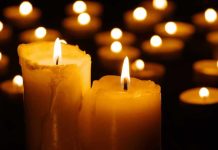 Lit candles glowing in the dark.