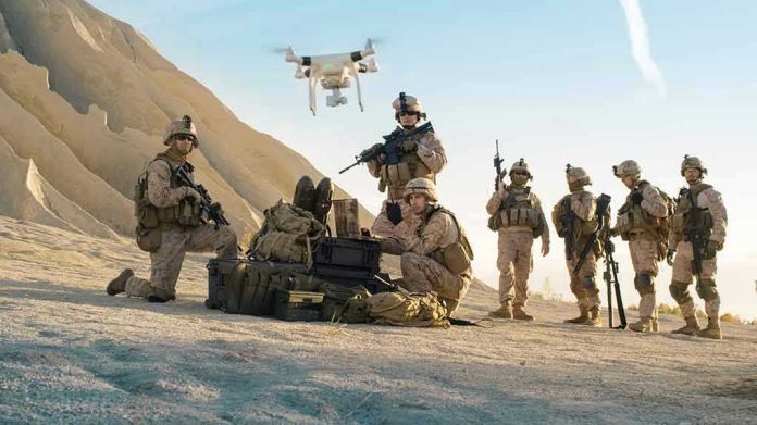 Soldiers operating a drone in a desert environment.