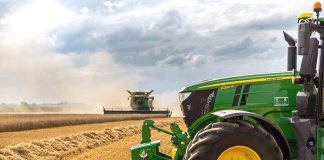Factory Jobs Return: The Real Stakes Behind John Deere’s Move A green tractor in a wheat field.