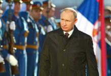 Putin Tried to Spin a Crisis A man in dark coat at a military event.