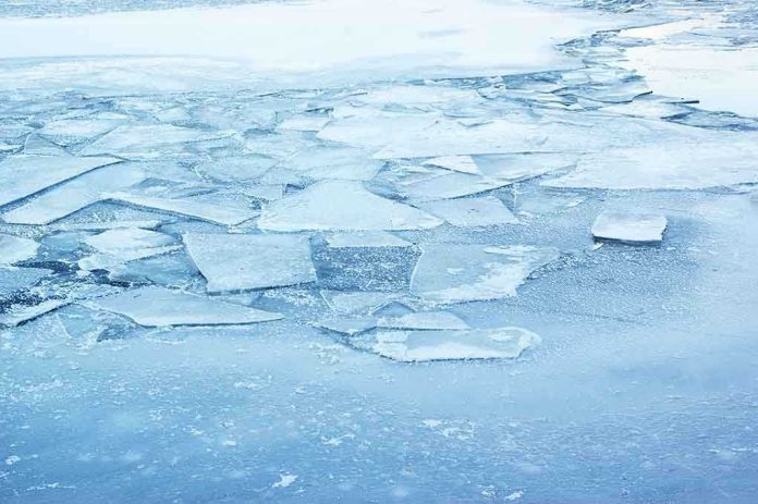 shutterstock_147580883.jpg A frozen lake with cracked ice and blue hues