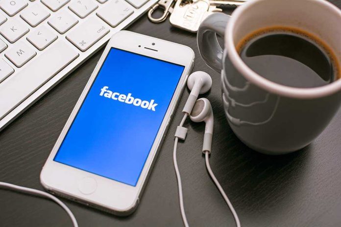 shutterstock_170062403.jpg Smartphone displaying Facebook logo next to a cup of coffee and earphones