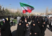 Live Rounds Fired: Iranian Protests Explode Group of women in black attire marching with an Iranian flag