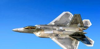 Fighter jet in flight against a clear blue sky.