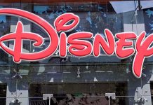 Vacuum Cleaner SHOCKER- Airbnb Host ARRESTED Near Disney Bright red Disney logo displayed on a storefront window
