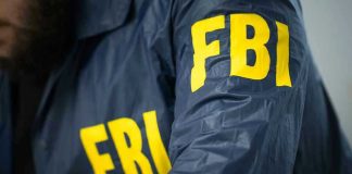 Iran Hackers Target FBI Director Email FBI jacket with yellow letters.