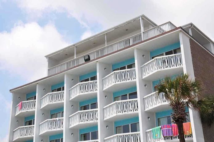 shutterstock_148328069.jpg Exterior view of a beachfront hotel with balconies and colorful towels hanging