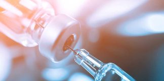 Shocking CPAC Speech: RFK Jr. Targets Vaccines Close-up of a syringe drawing liquid from a vial