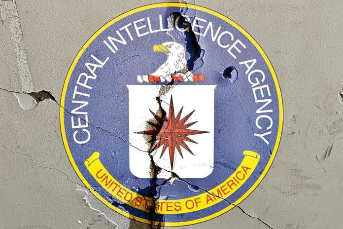 Cracked CIA logo on weathered wall.