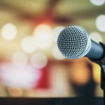 Microphone with blurred lights in the background.