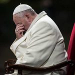 HOLY WAR Erupts Between Trump and Pope Pope sitting with his head bowed and hand covering his face