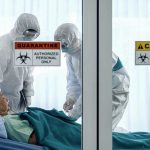 HANTAVIRUS Outbreak: Plague Ship Docks Amid Panic Healthcare workers in protective gear in quarantine room.