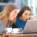 Gut-Brain BREAKTHROUGH — Coffee’s Hidden Mental Power Two women surprised while looking at a laptop.
