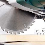 Close-up of a circular saw blade cutting through a piece of wood