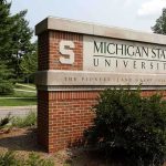 Sign for Michigan State University surrounded by greenery