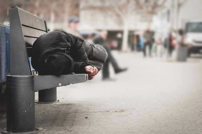 1016111287 Person sleeping on a bench in a public area.
