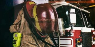 Firefighter gear hanging in front of fire truck.