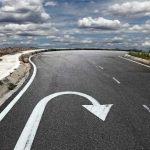 Curved road with a U-turn arrow marking.