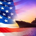 American flag overlaying warship at sunset.