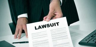 JUST IN — FTC Shockingly Targets POWERFUL Medical Group Person holding a document titled LAWSUIT in office.
