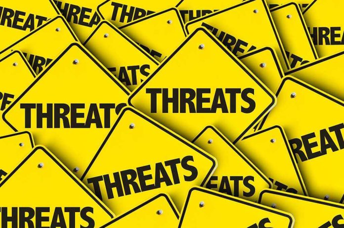 489638770 Yellow warning signs with the word THREATS.