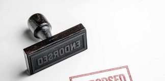 Rubber stamp with ENDORSED text on paper.