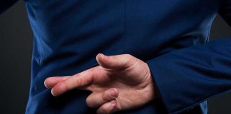 Grounded Fighters — Promises in QUESTION! Person crossing fingers behind their back in suit
